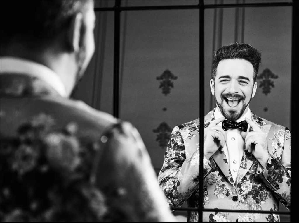 Ori Dagan fixes his bow tie in the mirror
